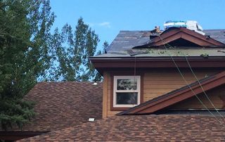 Roof repairs on a suburban home.