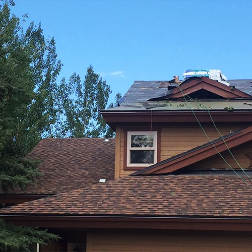 Roof repairs on a suburban home.