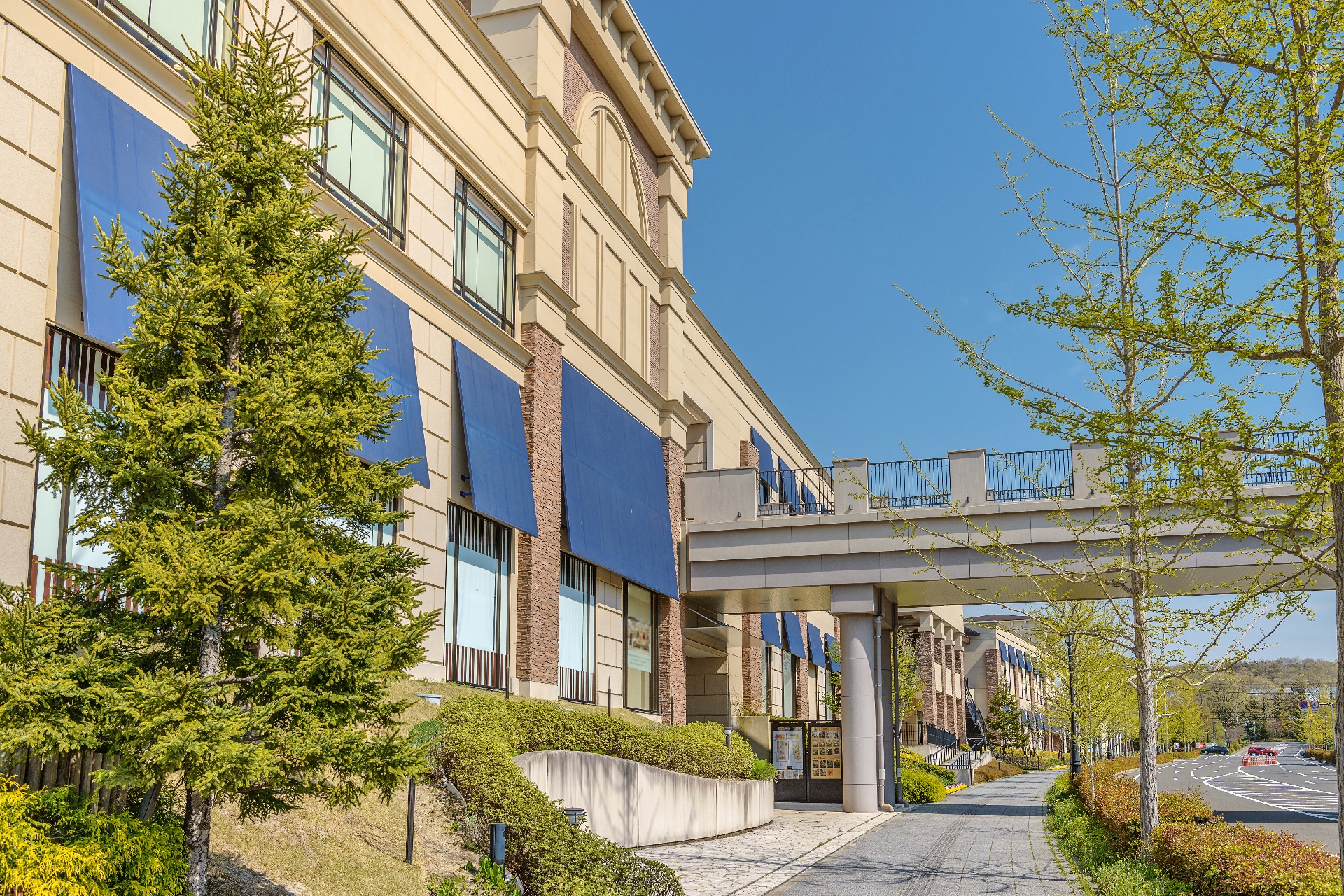 Commercial property with awnings and a bridge.